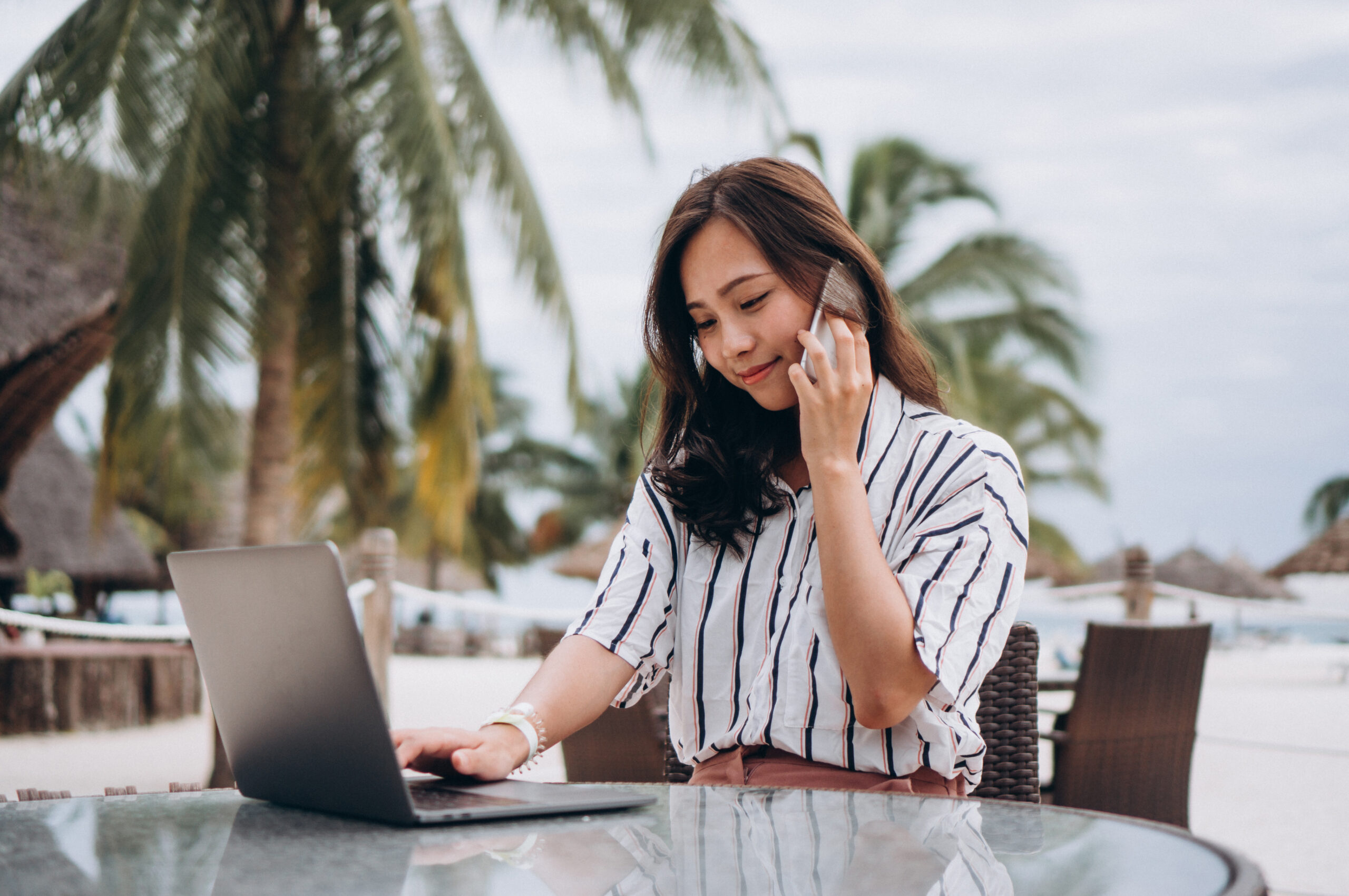 Asian woman working on laptop on a vacation